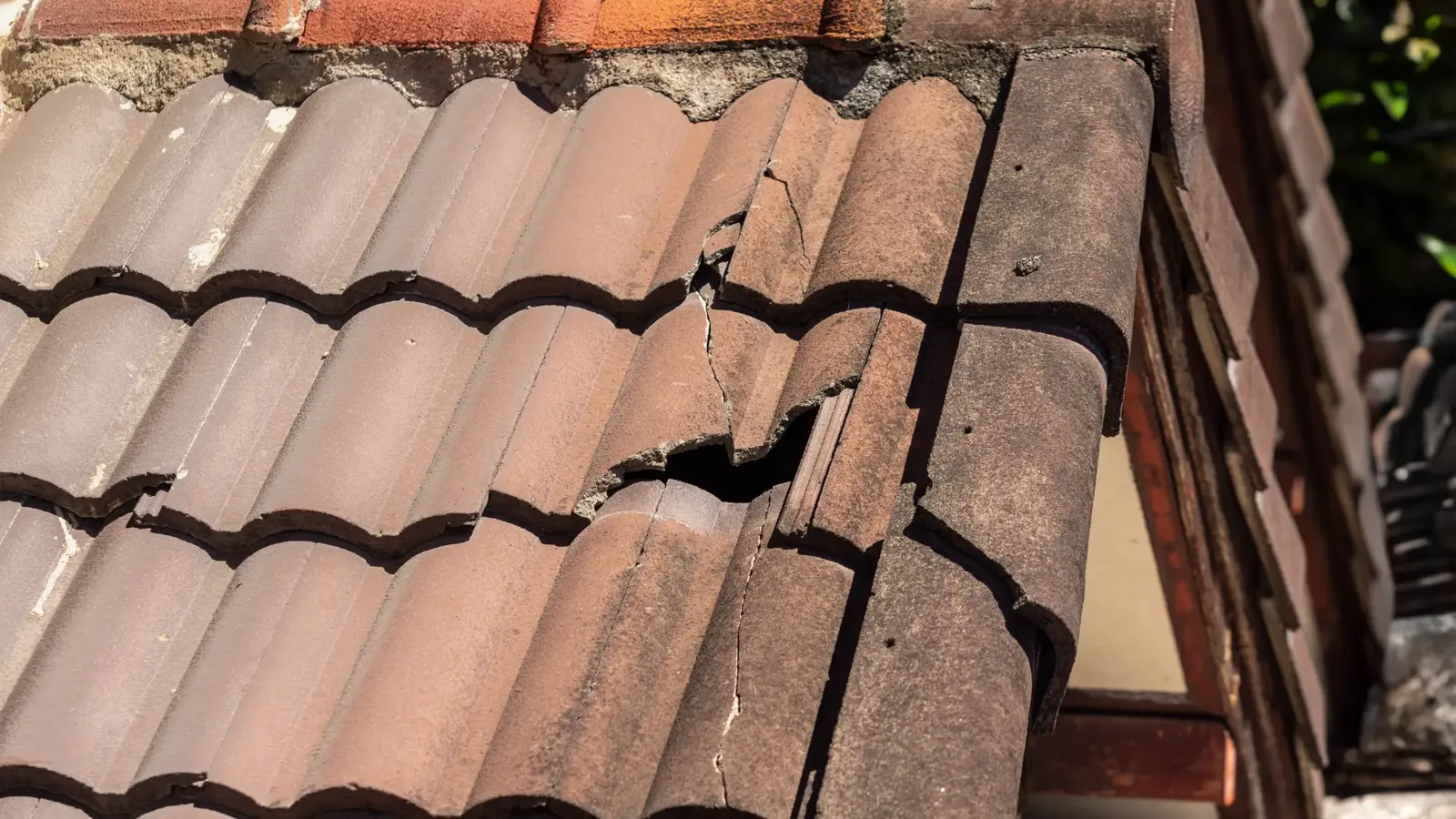 Roofer repairing a pitched tiled roof