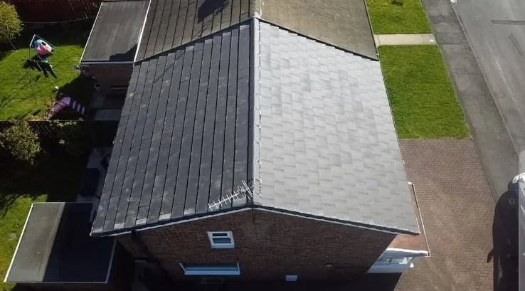 Aerial view of a completed dark grey tiled re-roof