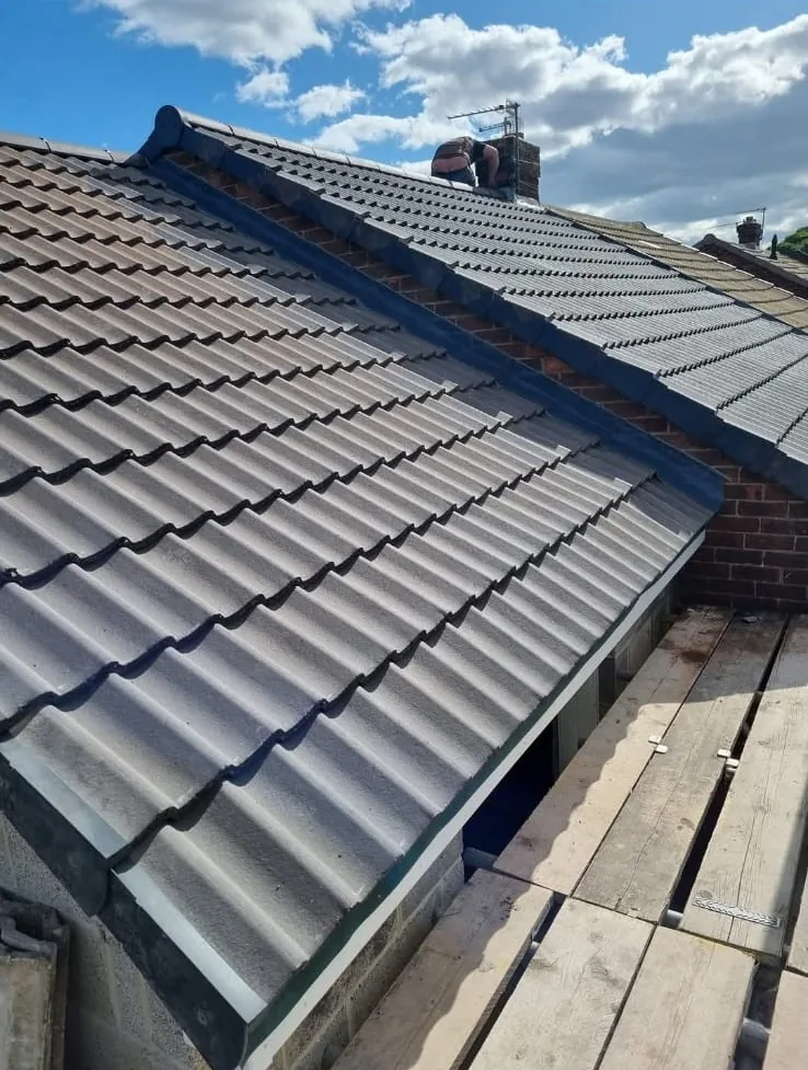 Dry verge caps along the edge of a newly tiled roof