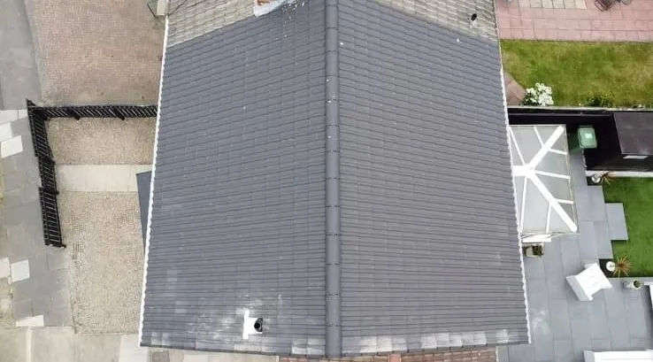 Top-down aerial view of a new grey tiled roof after a full re-roof